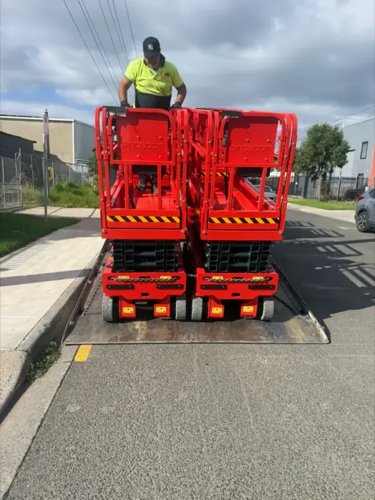 Red Sinoboom scissor lifts on delivery