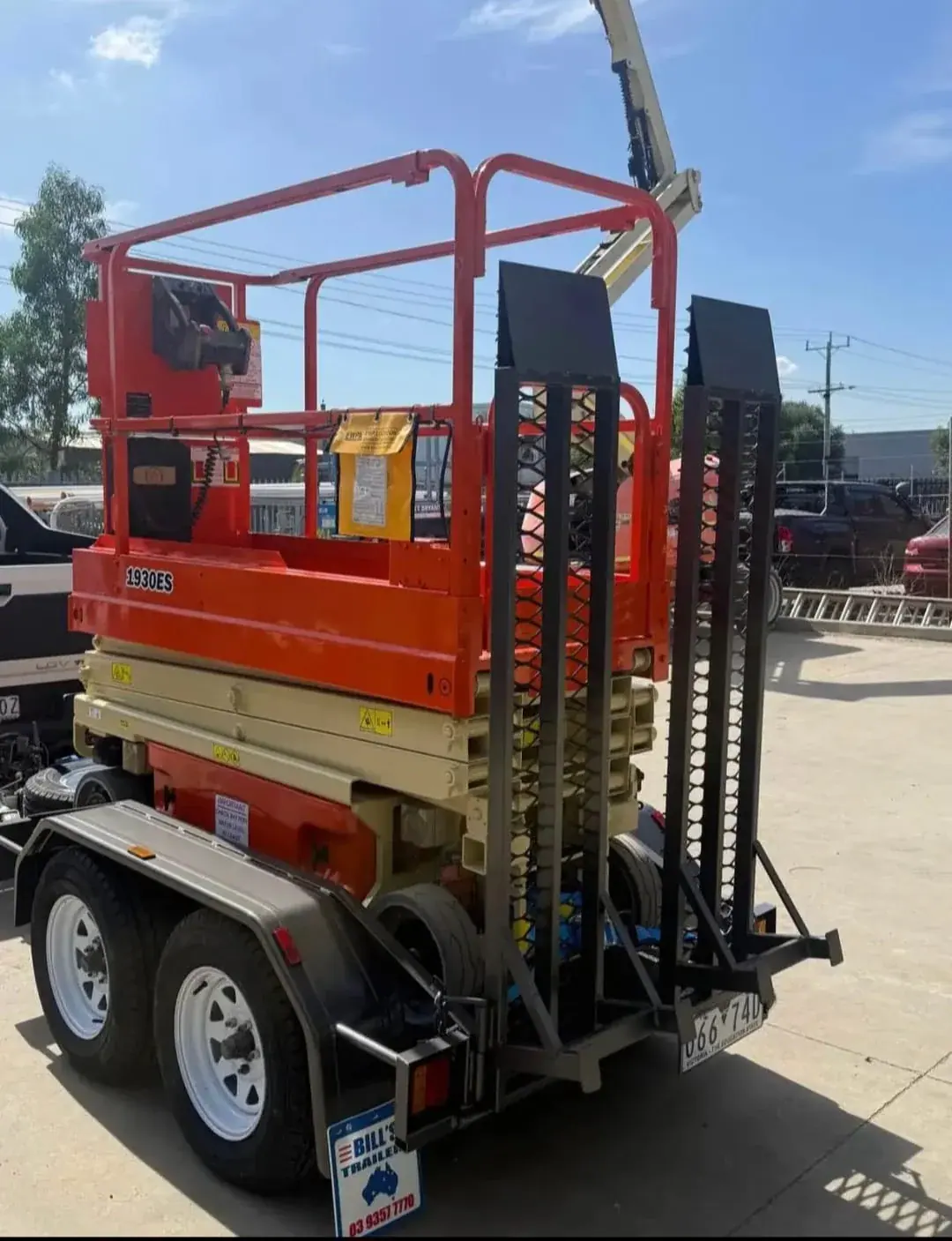JLG 1930ES scissor lift loaded on road-registered trailer - rear view